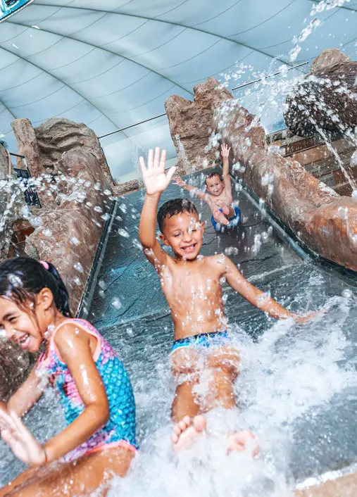 Children on the water slide in the Splash e Spa Tamaro children's area
